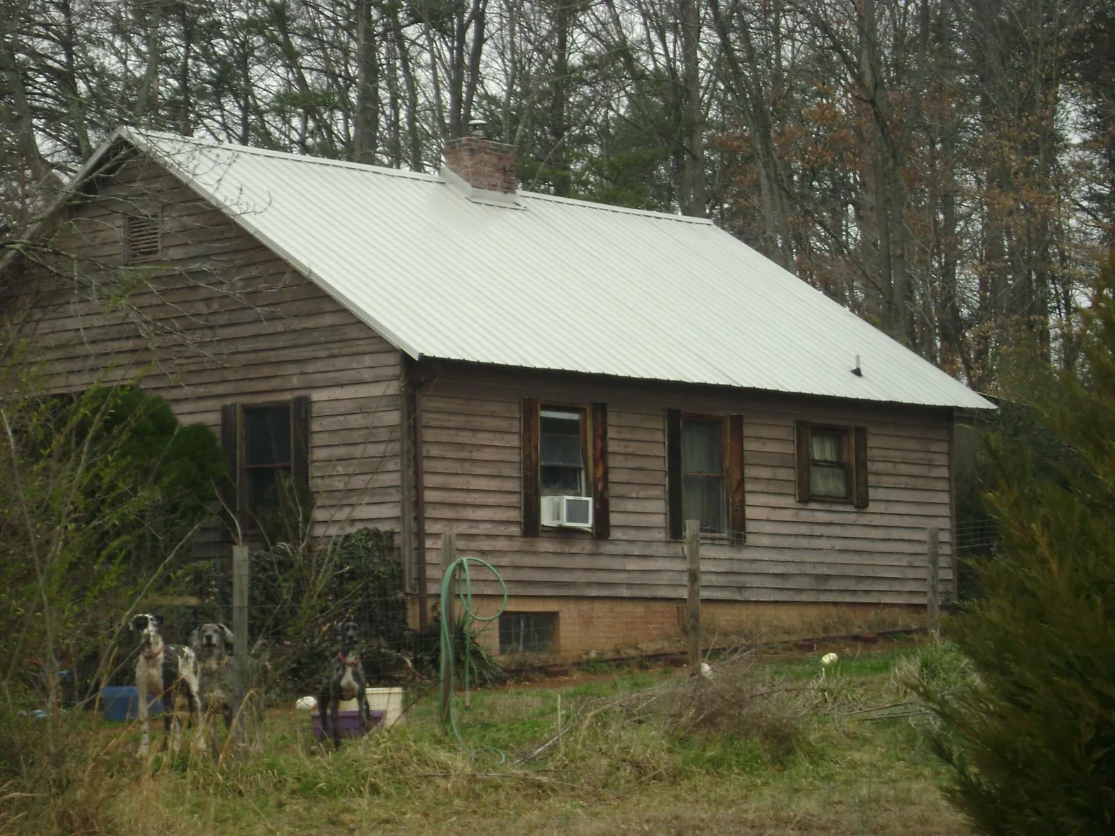 White metal roof on an old wood sided farmhouse, from a Metal Roof Installation job in Ivins